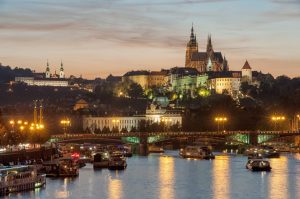 evening on Vltava river with boats and view lighted Prague Castle Czech Republic Czechia